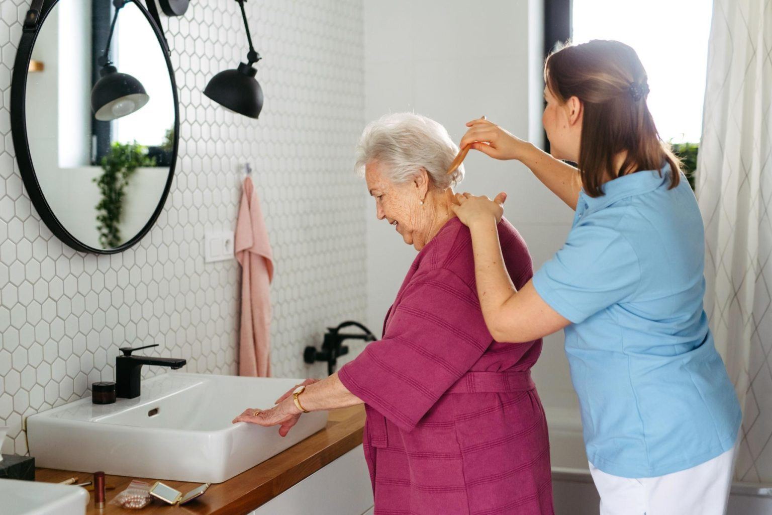 A caregiver assisting a client with mobility at home